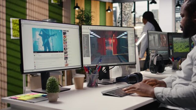 Game developer, works on video game, designing futuristic adventure in space. Black programmer uses modeling tools, animation software and programming commands for a virtual world.