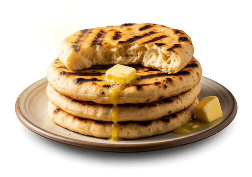 Stack of fresh homemade baked Pakistani taftan flatbread garnished with melted butter cube dripping down served hot on rustic ceramic plate isolated on white background stock photo.