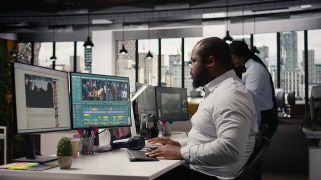 African american filmmaker working on post production process, cutting video footage for a timeline and cinematic transitions. Editing raw montage clips with color grading and visual effects.