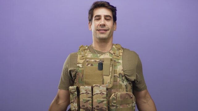 Man in camouflage tactical vest tilts head back showing dog tags and neck in studio purple backdrop; pride duty resilience.