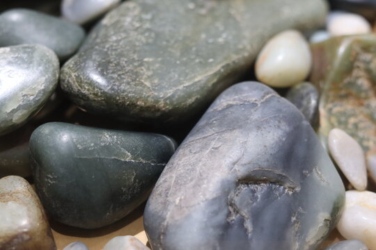 Close-up of nephrite  jade rocks with different colors. Geologic formation and mineralogy. Greens stones. 