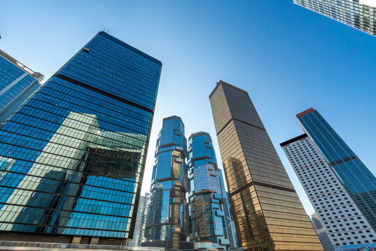 Low Angle View of Iconic Modern Glass Skyscraper Rising Against Deep Blue Sky