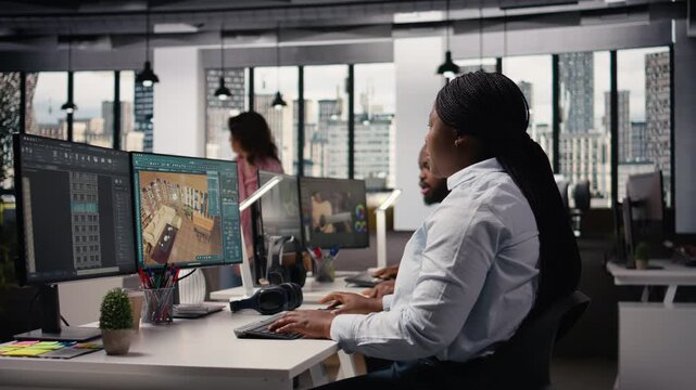 Black employees team using architectural CAD software for modern layout design, 3D rendering program on dual monitors. Architectural floor plan with tools and assets used for remodeling.
