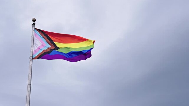 LGBT community. Tolerance and equality. World gay pride. Rainbow gay flag. Pride month. LGBTQ rainbow flag. LGBT rainbow flag waving against sky. Symbol of pride and LGBTQ. Colorful pride flag