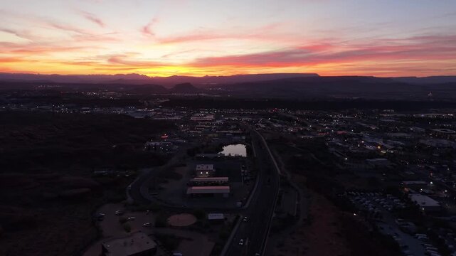 Aerial sunrise over St George city with mountain silhouettes in Utah