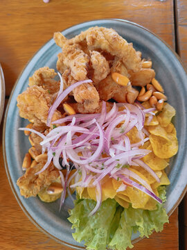 Peruvian chicharron de pescado plate with red onion and plantain