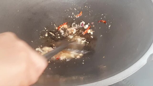 Aromatic kitchen spice paste being stir-fried in a pan until fragrant during cooking preparation