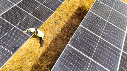 Close up of a technician carefully checking solar panel alignment. Professional working on a clean...