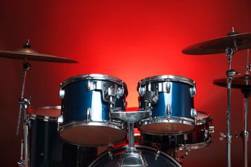 Obraz premium Drum kit on red gradient background. Musical instruments