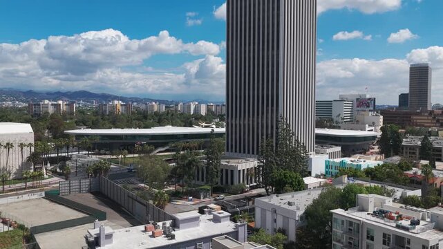Aerial low rising shot of the Brutalist-style David Geffen Galleries spanning Wilshire Blvd. at LACMA in Los Angeles, California. 4K