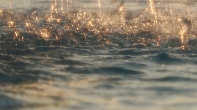 Bokeh effect blurring starbursts, light reflections, and water splashes from a fountain.