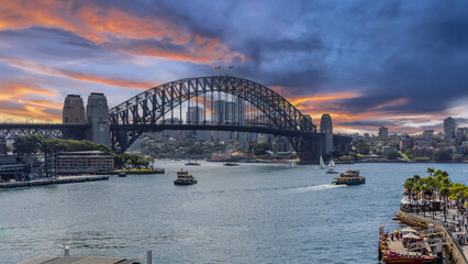 Obraz premium View of Sydney Harbour and Circular Quay and Sydney Harbour Bridge in on beautiful Autumn Afternoon beautiful colours in the Sky Sydney NSW Australia