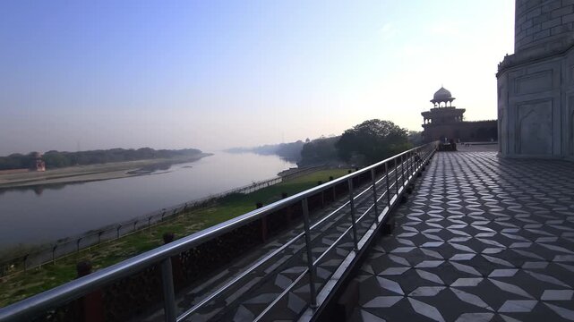 Scenic view of the Yamuna River in Agra from Taj Mahal, India. The iconic Mughal monument is seen alongside calm river waters and surrounding landscape, capturing heritage, architecture.