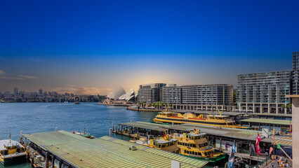 Fototapeta premium view of Sydney Harbour and Circular Quay on a Beautiful Autumn Afternoon lovely colours of the sky in Sydney NSW Australia