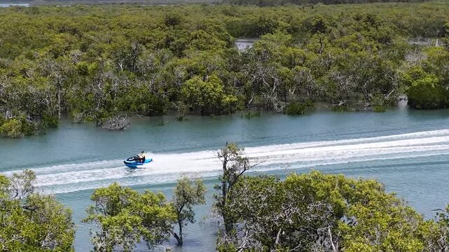 Aerial View of a Personal Watercraft Speeding Through Mangrove Channels