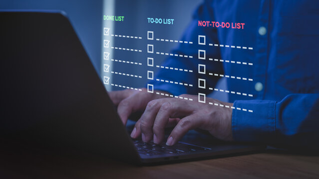 Businessman using laptop for productivity task management with to-do list and not-to-do list. Work planning, project efficiency, and time management concept on computer device.