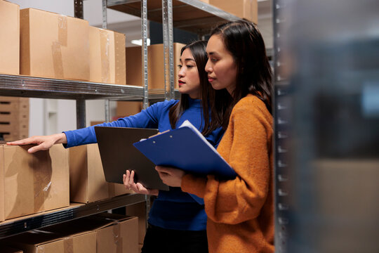 Postal service warehouse workers managing inventory and parcels quality control. Storehouse employee showing logistics managers goods storing and explaining dispatching operations