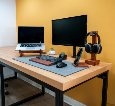 Minimal home office desk with laptop monitor keyboard headphones workspace productivity remote work and digital business concept