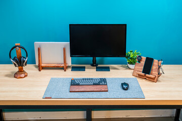Naklejka premium Minimal home office desk with laptop monitor keyboard headphones workspace productivity remote work and digital business concept