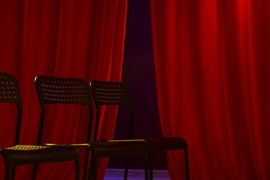 Empty seats near red curtains in audition room