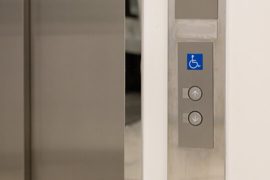 Close-up of elevator control panel featuring accessibility symbol
