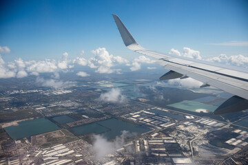 Fototapeta premium Aerial view of Miami industrial district with warehouses, lakes, roads and residential neighborhoods in Florida, USA. g.