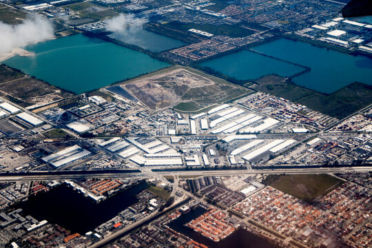 Aerial view of Miami industrial district with warehouses, lakes, roads and residential neighborhoods in Florida, USA. g.