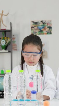 Asian Students Perform Bernoulli Principle Science Experiment with Ping Pong Ball