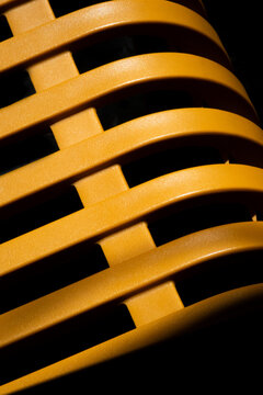 Orange woven plastic texture with curved interlocking patterns