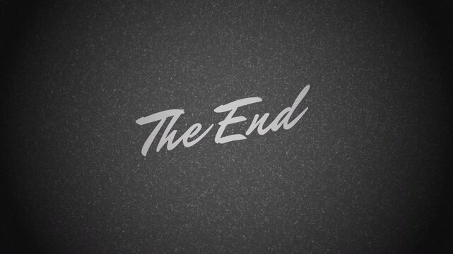 The End Vintage Film Reel Style High Quality 4K Footage. The end old film movie text writing with grain on dark background.