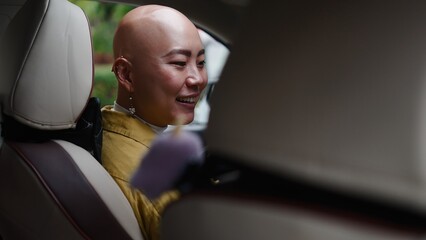 Fototapeta premium Asian woman smiling and riding in car, enjoying journey with friends