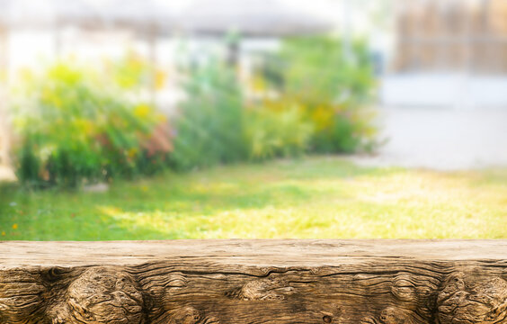 selective focus.Real wood table top texture on blur flower garden background