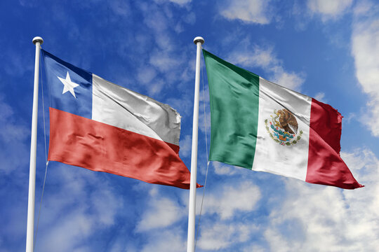 Chile and Mexico flags waving in a clear blue sky symbolizing a powerful diplomacy a strategic partnership, and a shared vision of unity for a sustainable future.