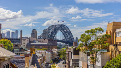 Fototapeta premium Historical Buildings at Sydney Rocks area with view of the Harbour Bridge in the Background. The Rocks is the Original Landing place of Captain Cook on Sydney Harbour and Circular Quay i