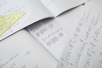 Naklejka premium Open copybooks with math formulas as background, closeup