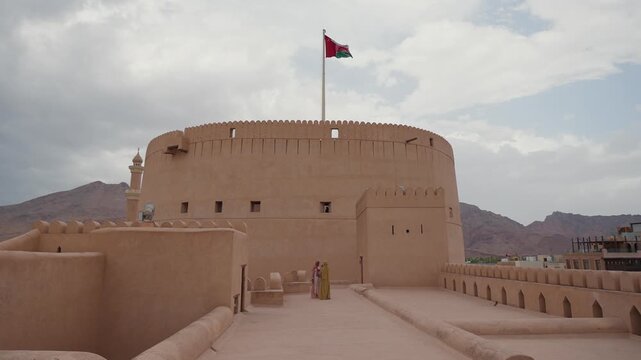 Ground view of the massive circular tower of Nizwa Fort, Oman
