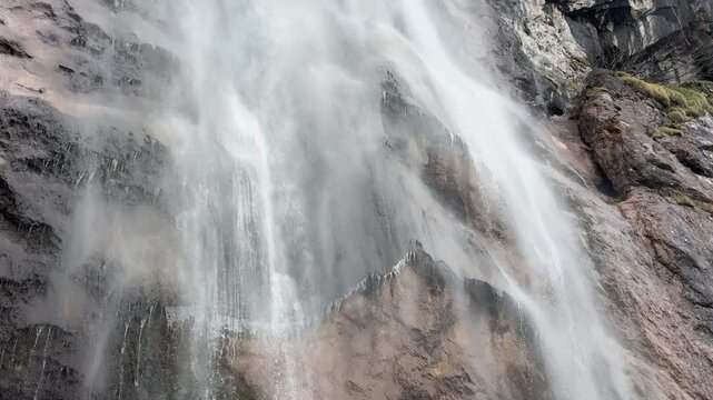 Single ground-level shot from upper cascade to base of Skakavac waterfall, showing water flowing over rocks into a misty pool.