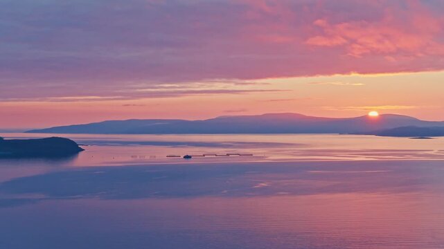 Kokelv, Hammerfest, Finnmark, Norway - The Sun Sets Behind the Mountains, Casting a Warm Glow Over the Tranquil Sea - Wide Shot
