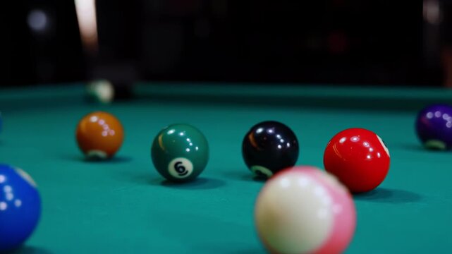 Colorful billiard balls setted up wooden rack triangle green felt pool table ready to play new game of snooker, is hitting by white cue ball for opening start first break shot, sport activity indoors