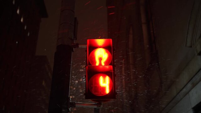 Neon Reflections On Wet Streets. City Street Illuminated By Neon Signs As Pedestrians Wait At Signals