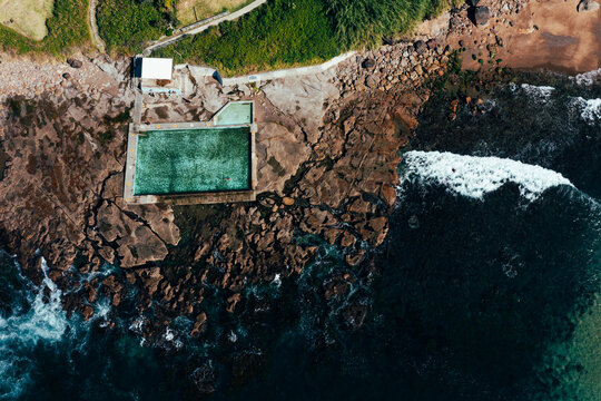 Aerial view of the picturesque Coalcliff Ocean Pool situated at the base of the escarpment on the Illawarra Coastline, minutes north of Wollongong, NSW Australia.