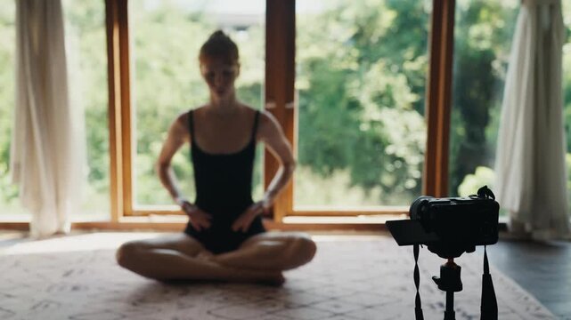 Woman vlogging yoga class at home