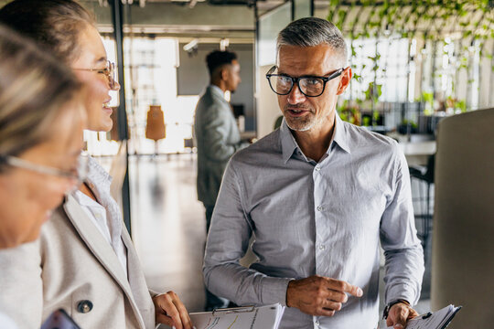 Senior consultant delivering client pitch with confident energy