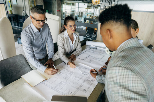 Expert Engineers Thoroughly Scrutinize Detailed Blueprints To Promote City Expansion And Building Projects