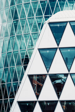 Abstract triangles pattern in modern glass exterior on facade architecture building delivers geometric texture and striking contemporary design