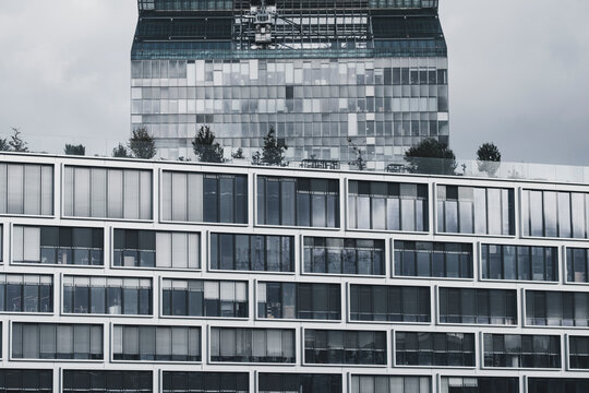 Monochrome urban windows grid on modern facade architecture building forms geometric exterior rhythm for contemporary documentary and design use