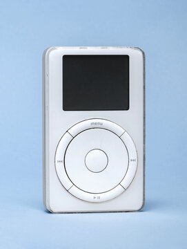 First generation Apple iPod standing on blue background