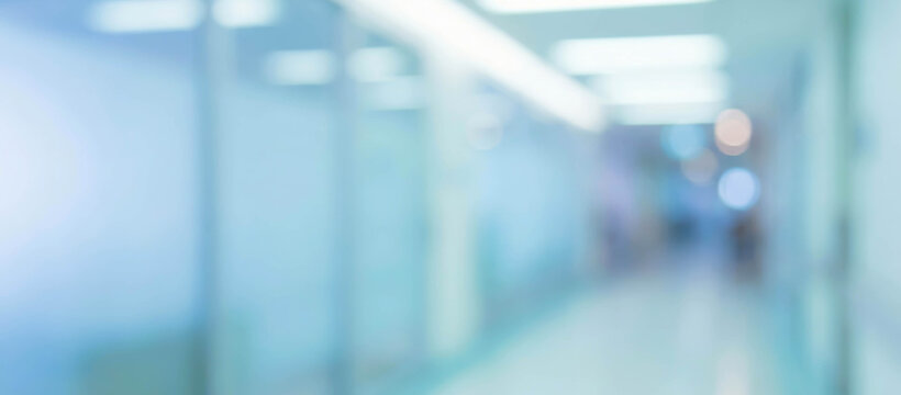 A softly blurred image depicting an interior corridor with blue tones, suggesting a clinical or modern environment, creating a sense of calm and spaciousness.