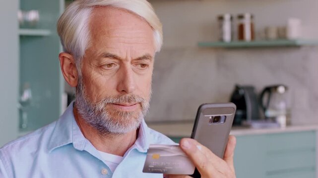 Stress, man and credit card with phone in home for payment decline, overdue bills and overwhelmed. Worry, mature person and banking app in kitchen with insufficient funds, debit due date and pressure