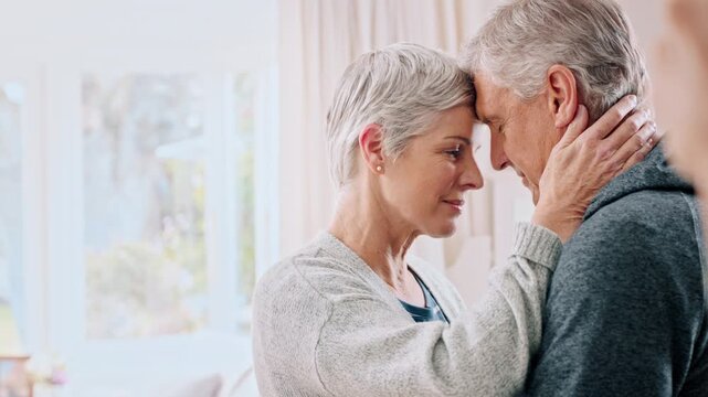 Senior, happy couple or dancing with hug in home for love, romance or anniversary together. Elderly, man or woman with forehead touch, embrace or comfort for romantic relationship or bonding in house